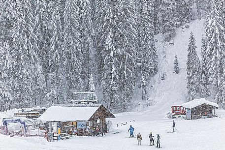 Skiers under heavy snowfall