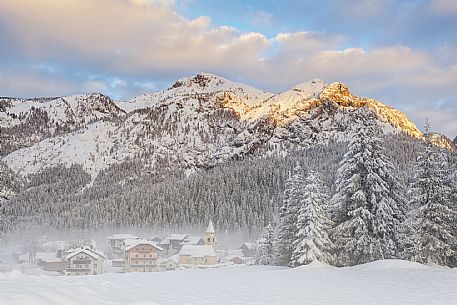 Sunrise on the Dolomites of Sappada and its traditional houses