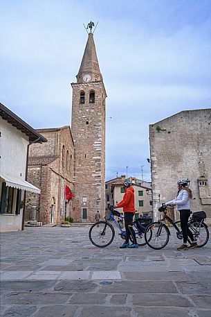 Cyclists in Campo dei Patriarchi in front of St. Euphemia's Basilica.