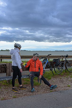 Cyclists resting on a bench.