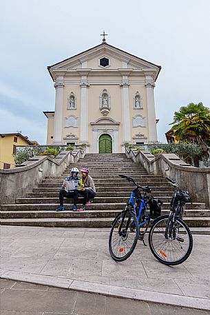 Cyclists sitting on the stairs in front of St. Adalbert Cathedral.