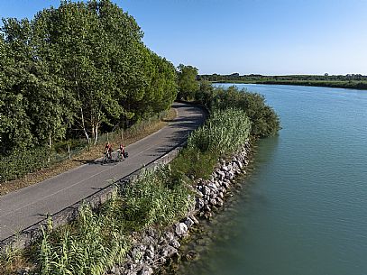 Cyclists along the Tagliamento river.