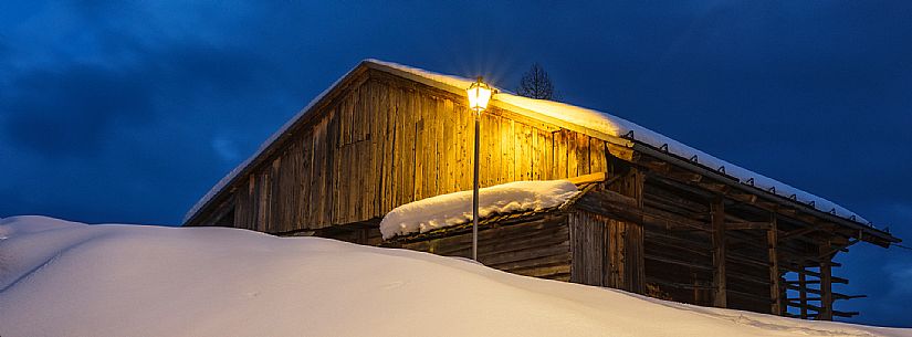 Typical Sauris chalet in winter in Sauris di Sopra