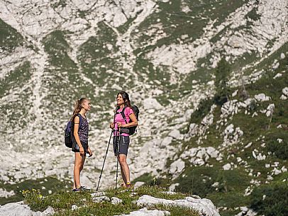 Trekking from the Celsio Gilberti Refuge, along the Bila Peč botanical path and further along the path that leads to the Marussic bivouac, on the suggestive karst plateau of Foran dal Mus. Prealpi Giulie Natural Park, MAB Unesco.