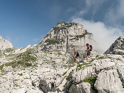 Trekking from the Celsio Gilberti Refuge, along the Bila Peč botanical path and further along the path that leads to the Marussic bivouac, on the suggestive karst plateau of Foran dal Mus. Prealpi Giulie Natural Park, MAB Unesco.