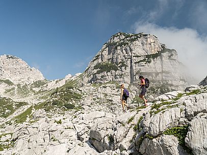 Trekking from the Celsio Gilberti Refuge, along the Bila Peč botanical path and further along the path that leads to the Marussic bivouac, on the suggestive karst plateau of Foran dal Mus. Prealpi Giulie Natural Park, MAB Unesco.