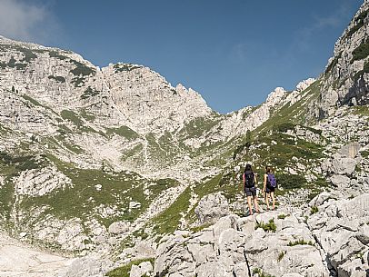 Trekking from the Celsio Gilberti Refuge, along the Bila Peč botanical path and further along the path that leads to the Marussic bivouac, on the suggestive karst plateau of Foran dal Mus. Prealpi Giulie Natural Park, MAB Unesco.