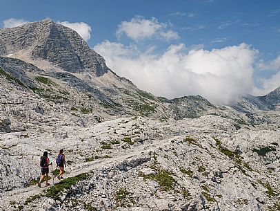 Trekking from the Celsio Gilberti Refuge, along the Bila Peč botanical path and further along the path that leads to the Marussic bivouac, on the suggestive karst plateau of Foran dal Mus. Prealpi Giulie Natural Park, MAB Unesco.