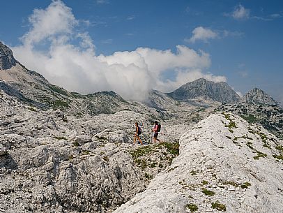 Trekking from the Celsio Gilberti Refuge, along the Bila Peč botanical path and further along the path that leads to the Marussic bivouac, on the suggestive karst plateau of Foran dal Mus. Prealpi Giulie Natural Park, MAB Unesco.