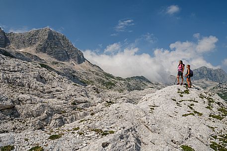 Trekking from the Celsio Gilberti Refuge, along the Bila Peč botanical path and further along the path that leads to the Marussic bivouac, on the suggestive karst plateau of Foran dal Mus. Prealpi Giulie Natural Park, MAB Unesco.