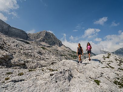 Trekking from the Celsio Gilberti Refuge, along the Bila Peč botanical path and further along the path that leads to the Marussic bivouac, on the suggestive karst plateau of Foran dal Mus. Prealpi Giulie Natural Park, MAB Unesco.