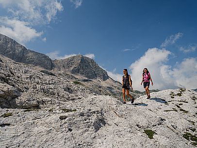 Trekking from the Celsio Gilberti Refuge, along the Bila Peč botanical path and further along the path that leads to the Marussic bivouac, on the suggestive karst plateau of Foran dal Mus. Prealpi Giulie Natural Park, MAB Unesco.