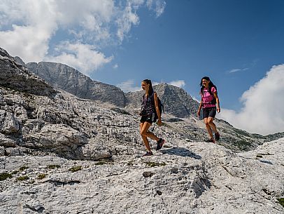 Trekking from the Celsio Gilberti Refuge, along the Bila Peč botanical path and further along the path that leads to the Marussic bivouac, on the suggestive karst plateau of Foran dal Mus. Prealpi Giulie Natural Park, MAB Unesco.