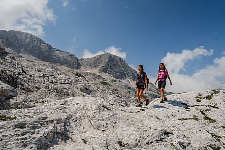 Trekking from the Celsio Gilberti Refuge, along the Bila Peč botanical path and further along the path that leads to the Marussic bivouac, on the suggestive karst plateau of Foran dal Mus. Prealpi Giulie Natural Park, MAB Unesco.