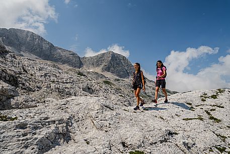 Trekking from the Celsio Gilberti Refuge, along the Bila Peč botanical path and further along the path that leads to the Marussic bivouac, on the suggestive karst plateau of Foran dal Mus. Prealpi Giulie Natural Park, MAB Unesco.