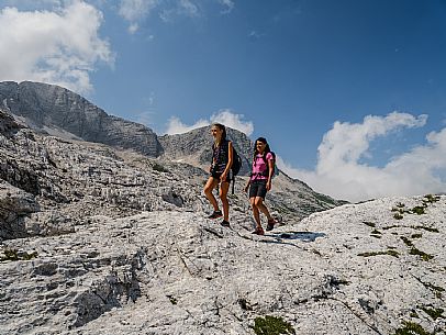 Trekking from the Celsio Gilberti Refuge, along the Bila Peč botanical path and further along the path that leads to the Marussic bivouac, on the suggestive karst plateau of Foran dal Mus. Prealpi Giulie Natural Park, MAB Unesco.