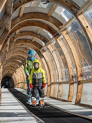 Teacher young woman and child learning alpine skiing in a school camp in Tarvisio.