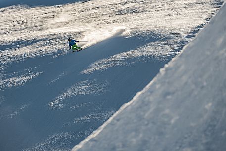 Teacher young woman and child learning alpine skiing in a school camp in Tarvisio.