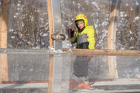 Teacher young woman and child learning alpine skiing in a school camp in Tarvisio.