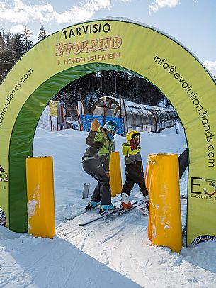 Teacher young woman and child learning alpine skiing in a school camp in Tarvisio.