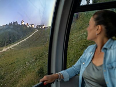 Lift up to Monte Santo di Lussari, enjoying the summer night opening of the telecabine. To enjoy the beautiful view of the Julian Mountains at sunset and the village lit up at night.