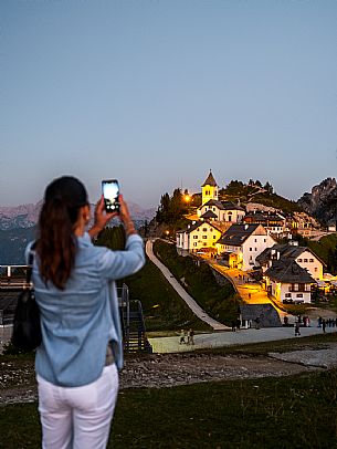 Lift up to Monte Santo di Lussari, enjoying the summer night opening of the telecabine. To enjoy the beautiful view of the Julian Mountains at sunset and the village lit up at night.