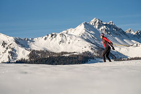 Cross-country skiing on the Plotze slope in Sauris di Sopra, with the iconic Bivera mountain in the background