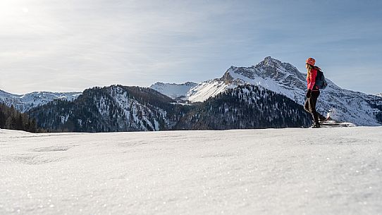 Snowshoe walk in Sauris di Sopra, with the iconic Bivera mountain in the background