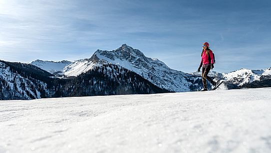 Snowshoe walk in Sauris di Sopra, with the iconic Bivera mountain in the background