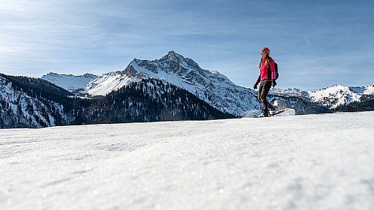 Snowshoe walk in Sauris di Sopra, with the iconic Bivera mountain in the background